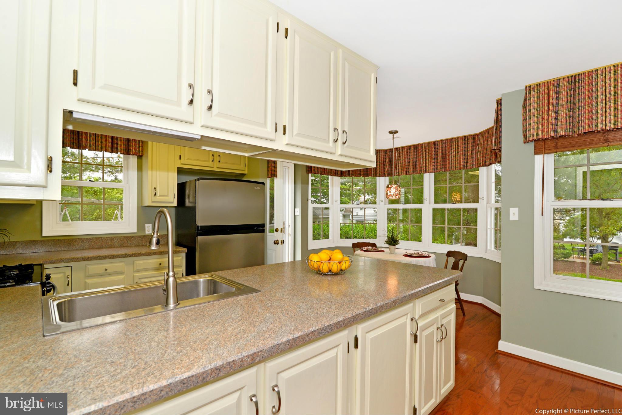 2488 Bear Den Road Frederick, MD 21701 - Photo 10 of 30 a kitchen with stainless steel appliances granite countertop a sink and a white cabinets