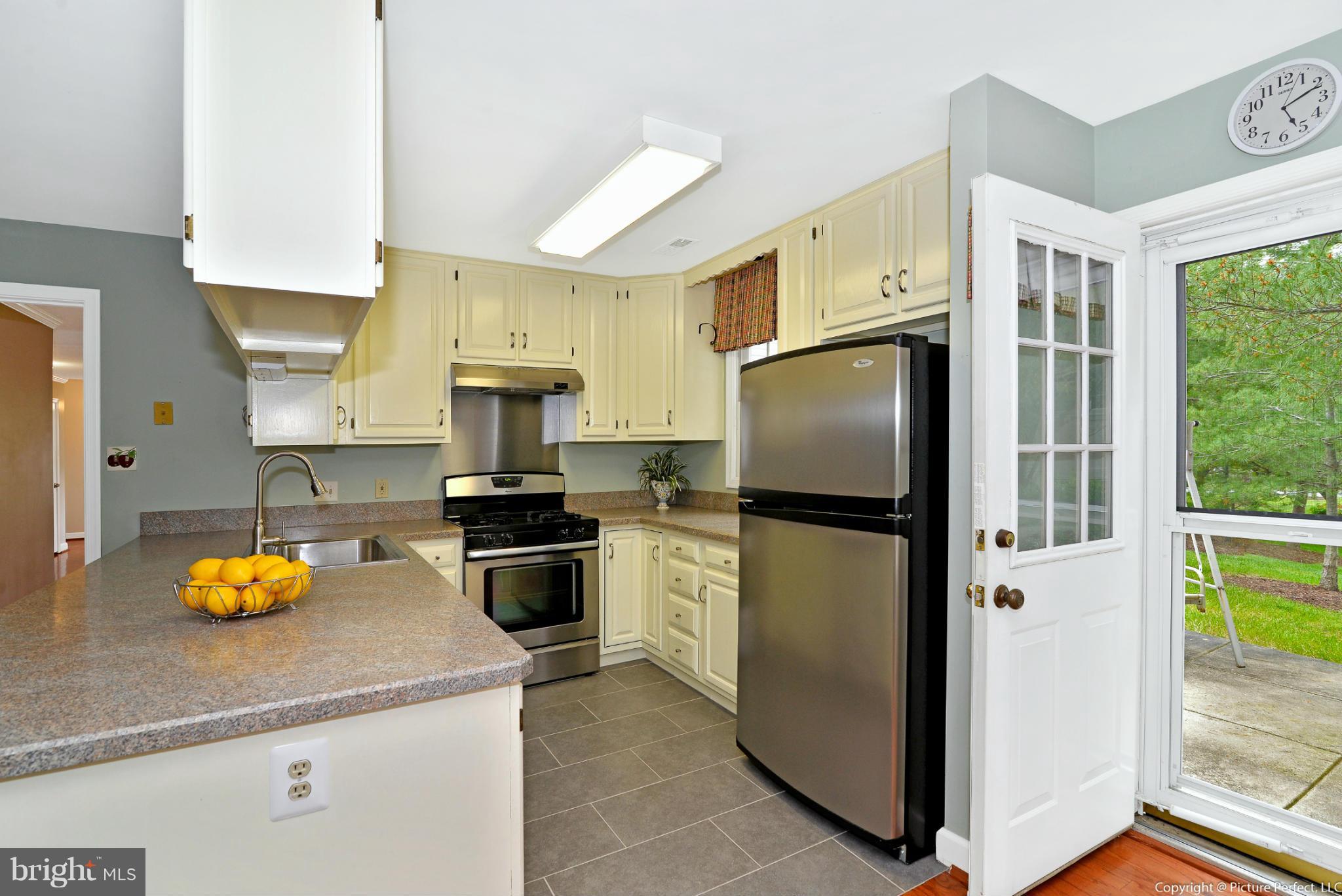 2488 Bear Den Road Frederick, MD 21701 - Photo 11 of 30 a kitchen with a refrigerator and a stove