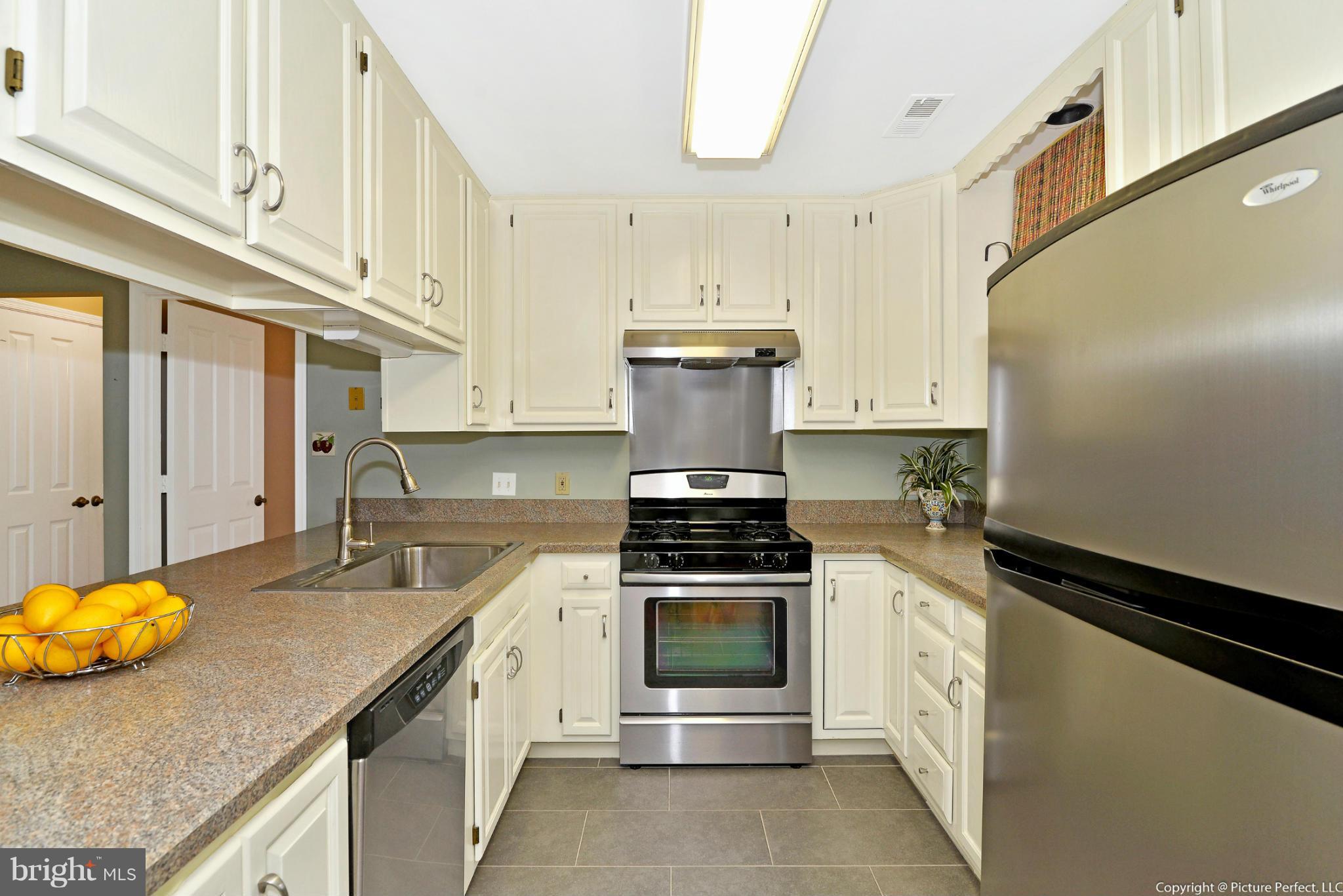 2488 Bear Den Road Frederick, MD 21701 - Photo 12 of 30 a kitchen with stainless steel appliances granite countertop a stove a sink and a refrigerator