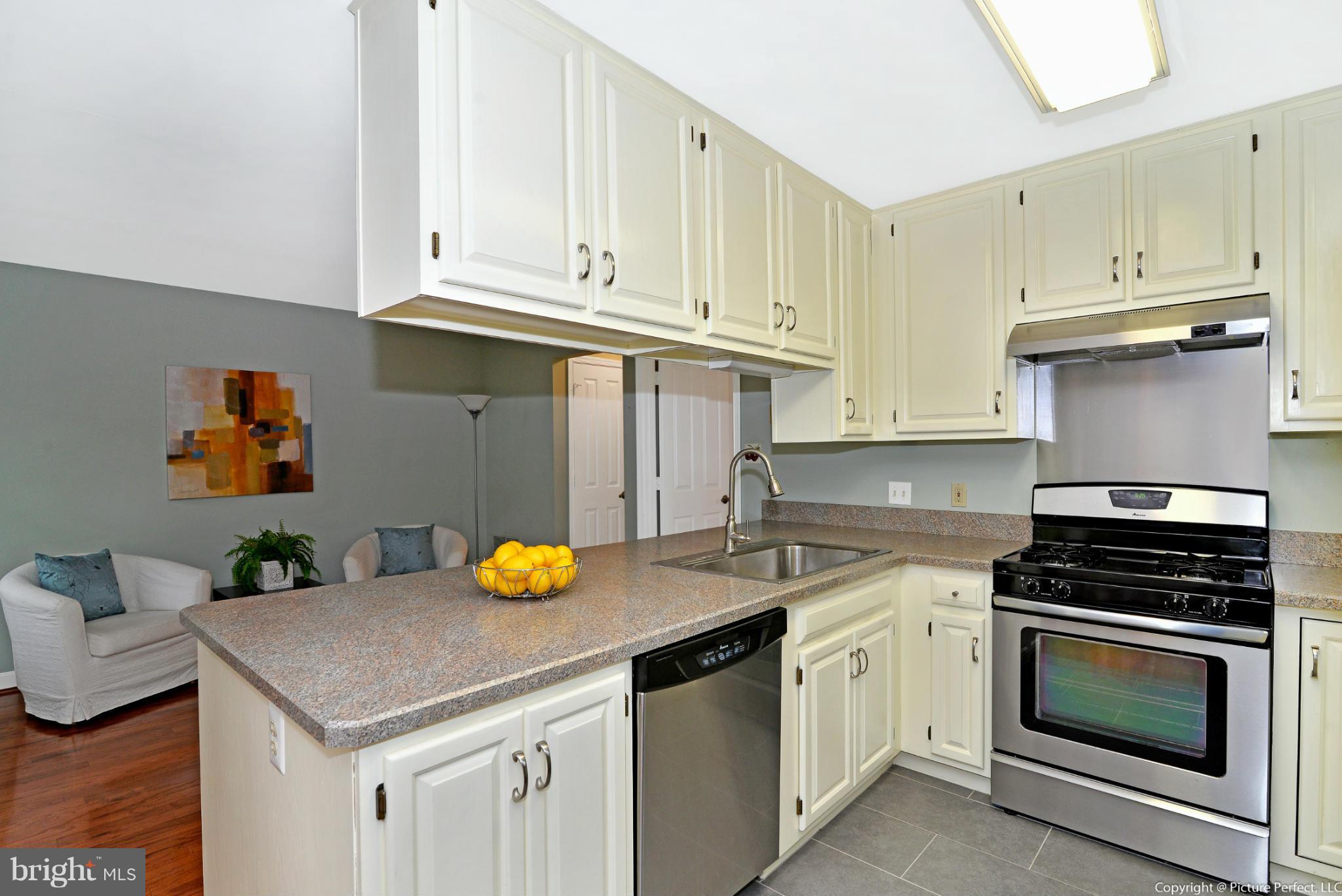 2488 Bear Den Road Frederick, MD 21701 - Photo 13 of 30 a kitchen with white cabinets and appliances