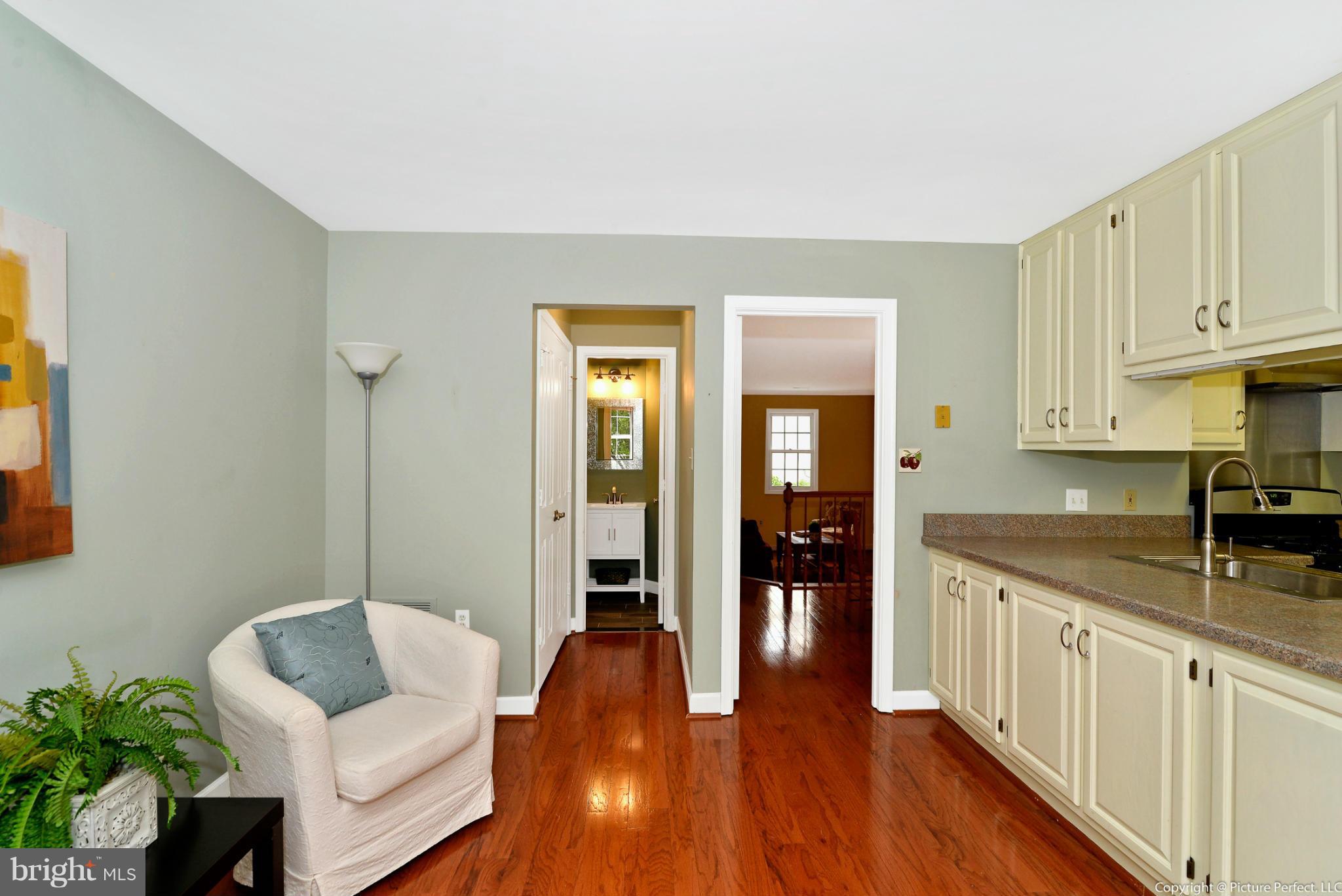 2488 Bear Den Road Frederick, MD 21701 - Photo 15 of 30 a living room with stainless steel appliances granite countertop furniture and wooden floor