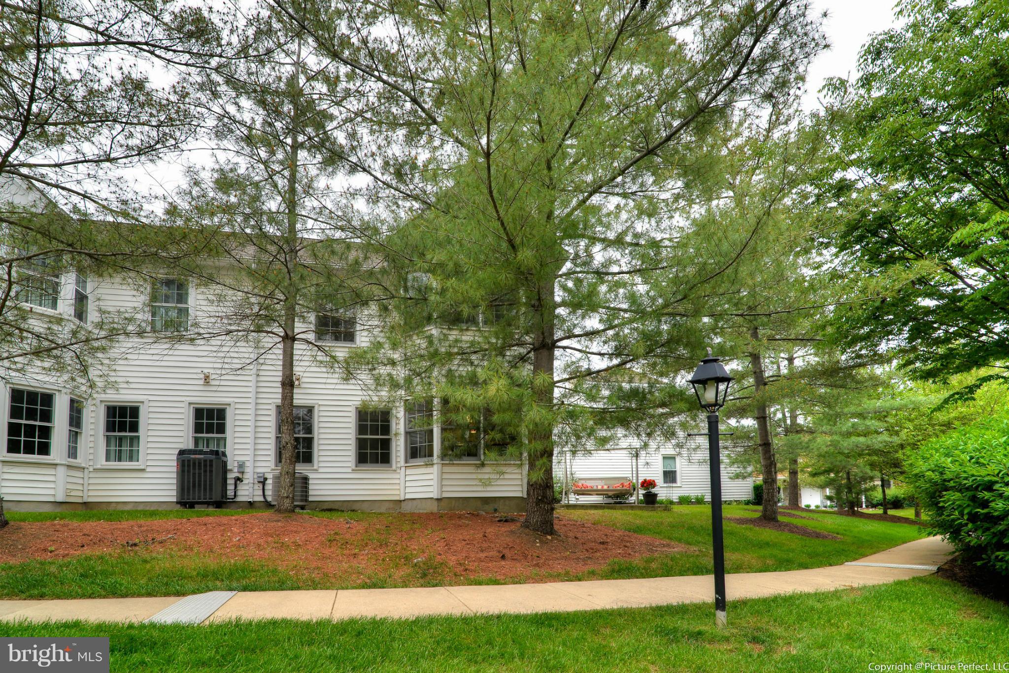 2488 Bear Den Road Frederick, MD 21701 - Photo 24 of 30 a view of a white house next to a yard with big trees