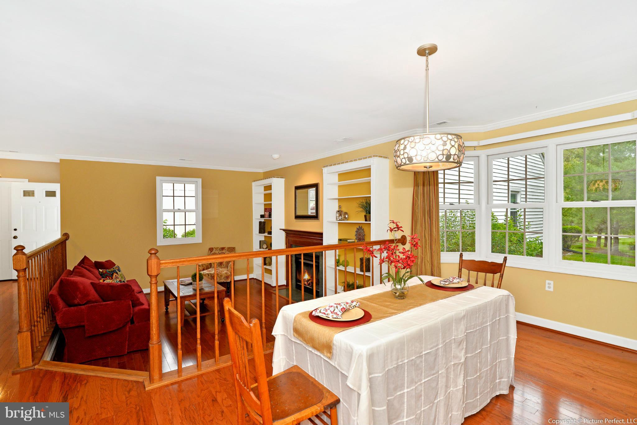 2488 Bear Den Road Frederick, MD 21701 - Photo 9 of 30 a living room with furniture a chandelier and a table