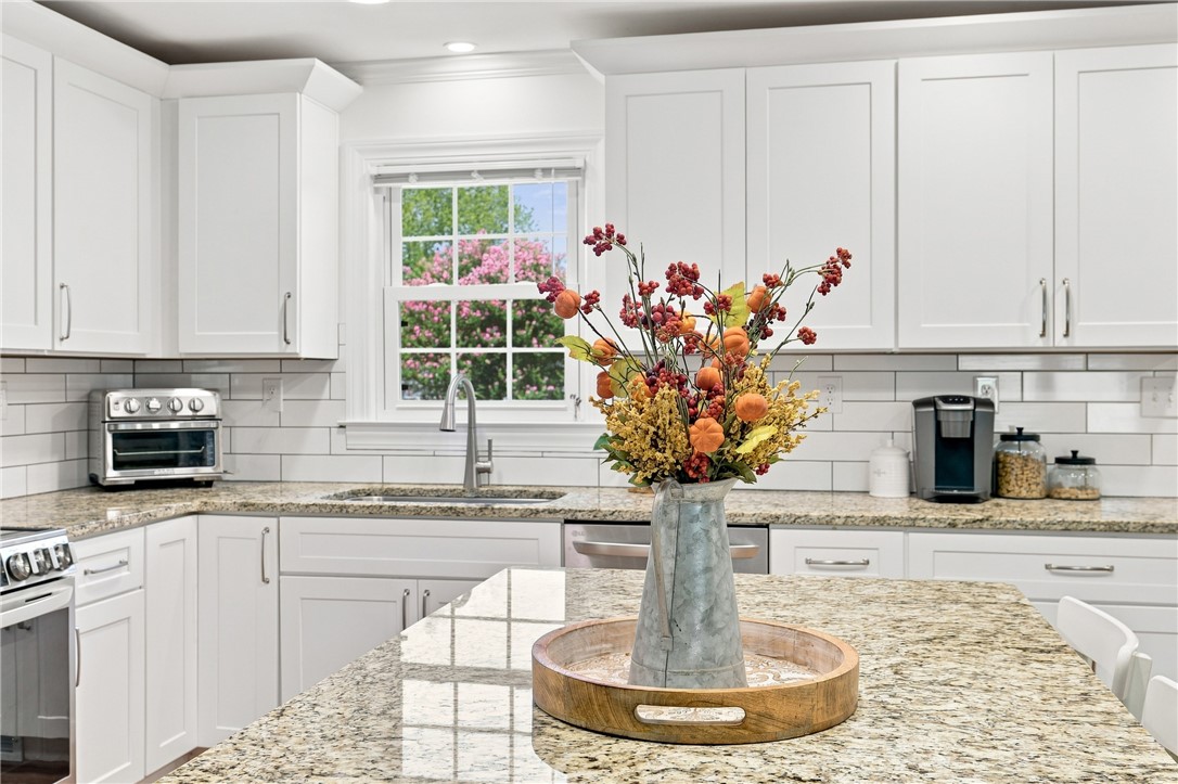204 Sylvia Road Easley, SC 29642 - Photo 15 of 36 White cabinetry and granite countertops define this bright, naturally illuminated kitchen.