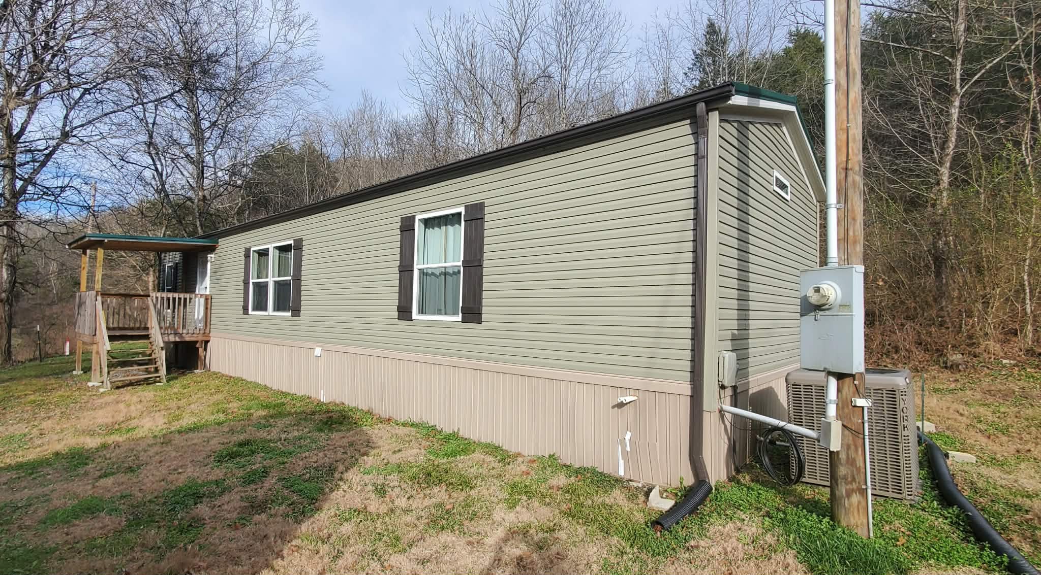 a backyard of a house with barbeque oven and seating space