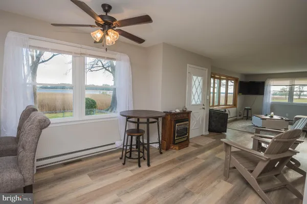 a work room with furniture and a large window