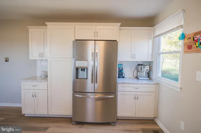 a white refrigerator freezer sitting in a kitchen