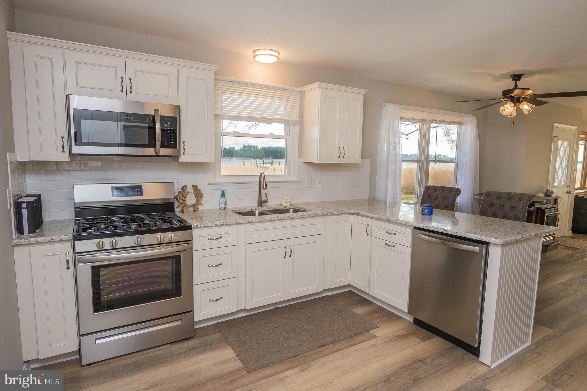 3555 Green Hill Church Road Quantico, MD 21856 - Photo 17 of 51 a kitchen with stainless steel appliances white cabinets a sink and a stove