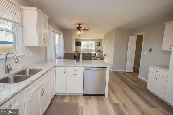 a kitchen with sink cabinets and wooden floor