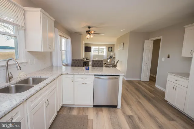 a kitchen with sink cabinets and wooden floor