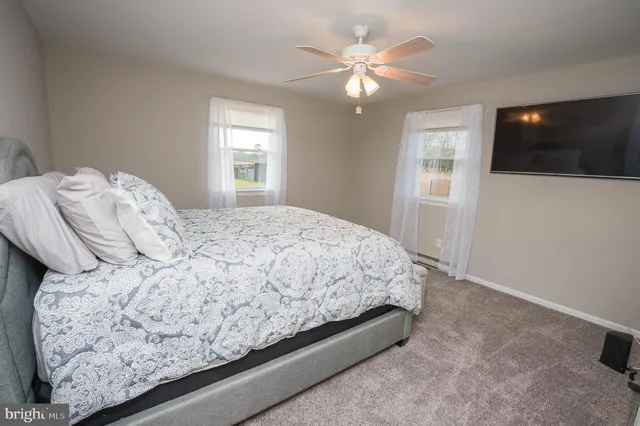 a bedroom with a large bed and a window