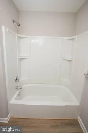 a bathroom with bathtub and shower