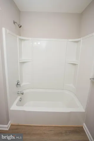 a bathroom with bathtub and shower