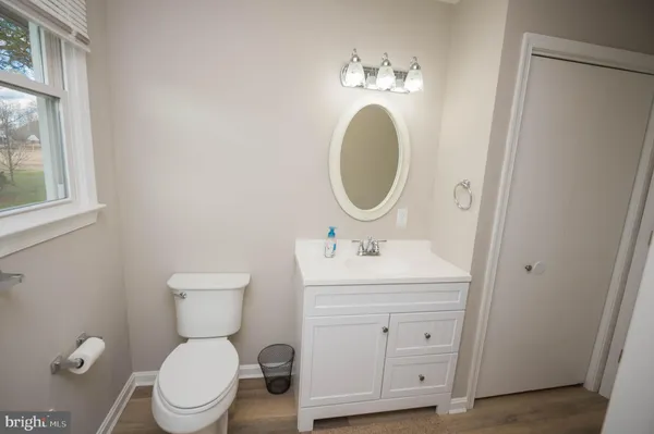 a bathroom with a toilet a sink and a mirror