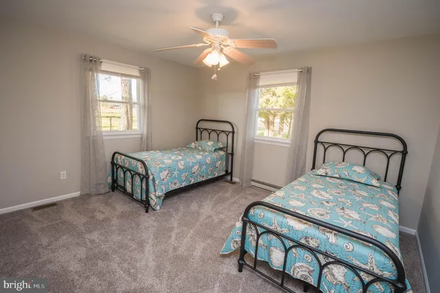 a bedroom with a bed window and a chandelier