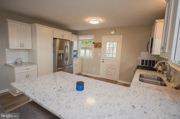 a kitchen with a sink a stove and refrigerator