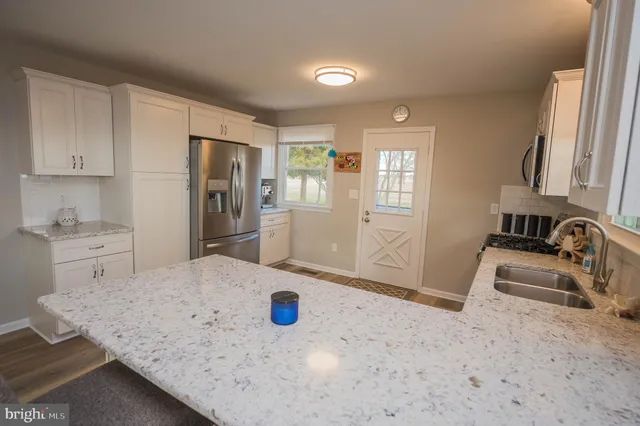 a kitchen with a sink a stove and refrigerator