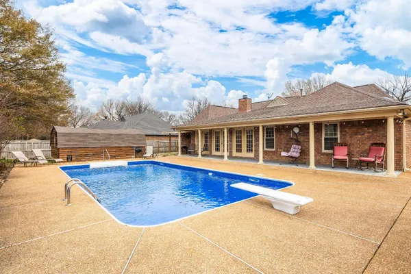 a view of a house with swimming pool and sitting area