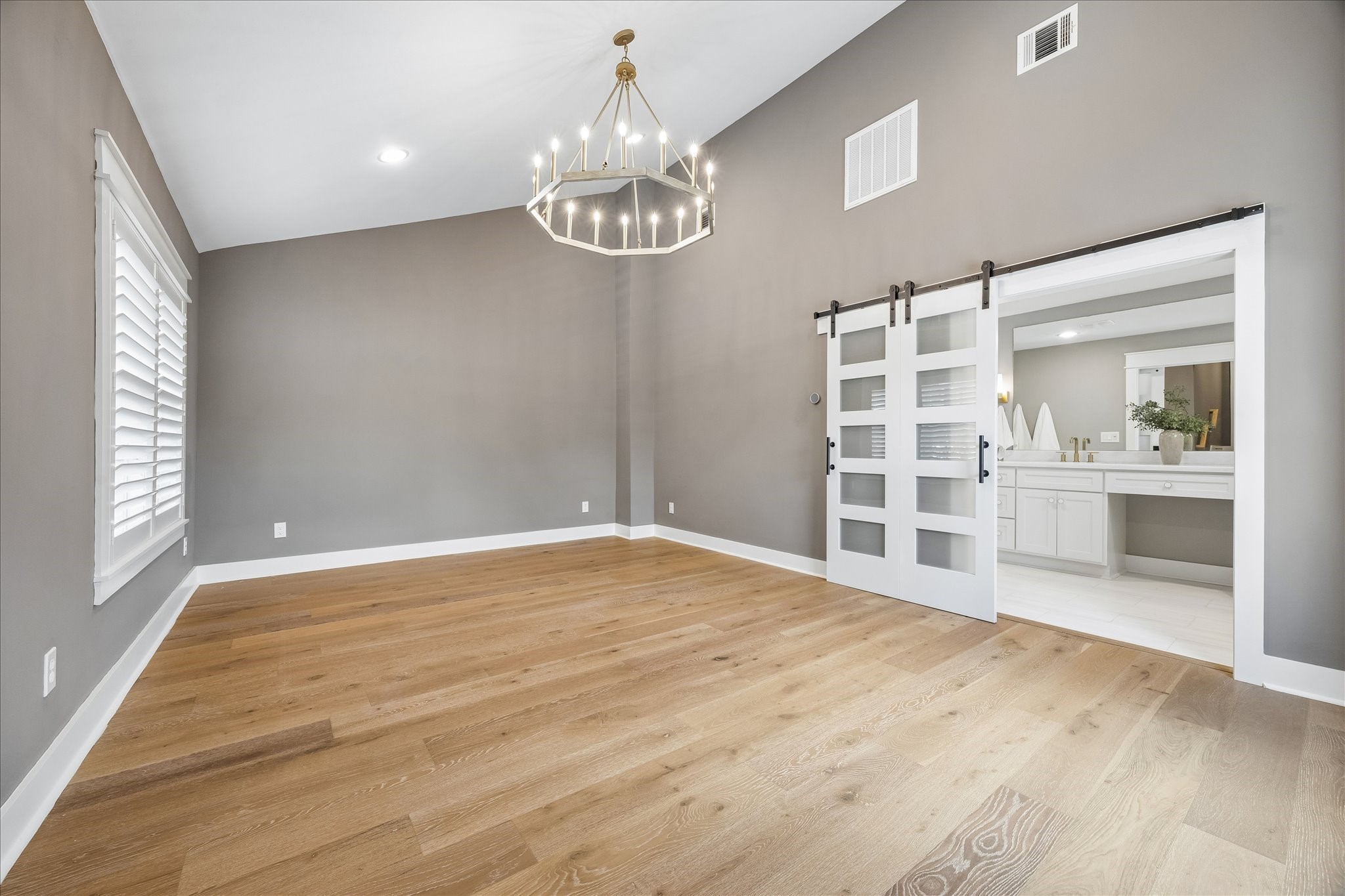1112 Merrill Street Houston, TX 77009 - Photo 6 of 42 Here is your primary suite, perfectly set apart for privacy. It’s a very generous 13x19 (approx.) retreat that boasts dramatic vaulted ceilings, giving the space an incredibly open and airy feel.