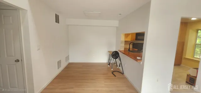 a view of a hallway with a white walls and stairs