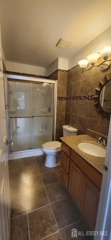 a bathroom with a sink mirror toilet and shower