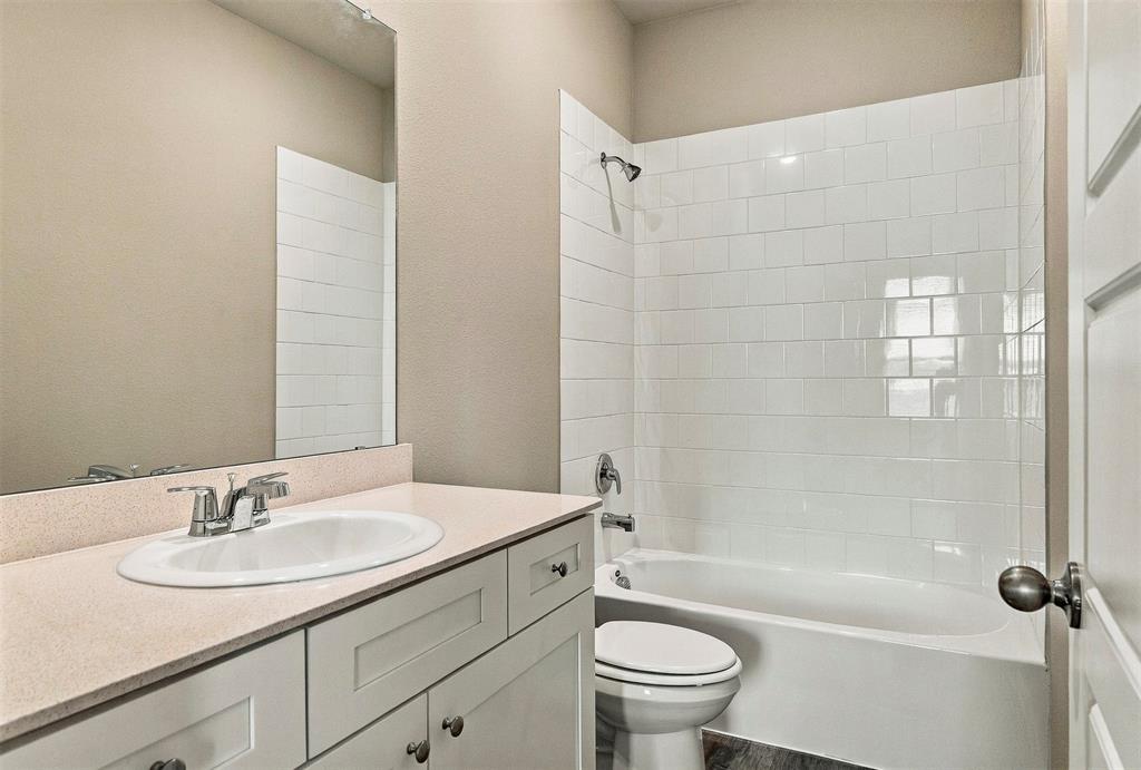 15932 Stableford Road Justin, TX 76247 - Photo 23 of 35 Built-in vanity with light-colored countertop, undermount sink, and chrome faucet