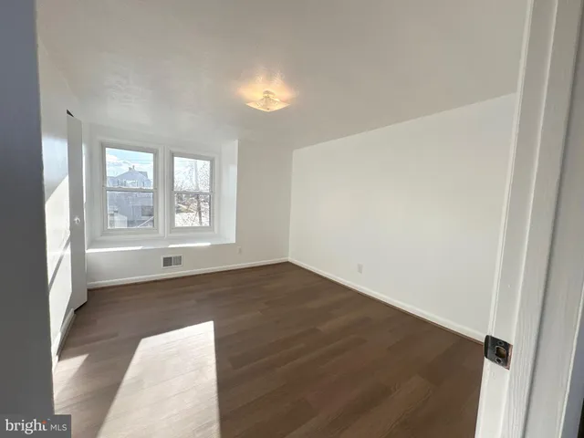 an empty room with windows and entrance