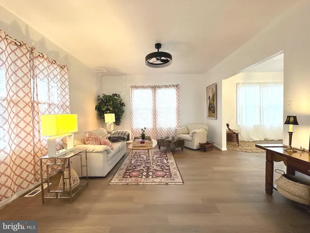 a living room with fireplace furniture and a window
