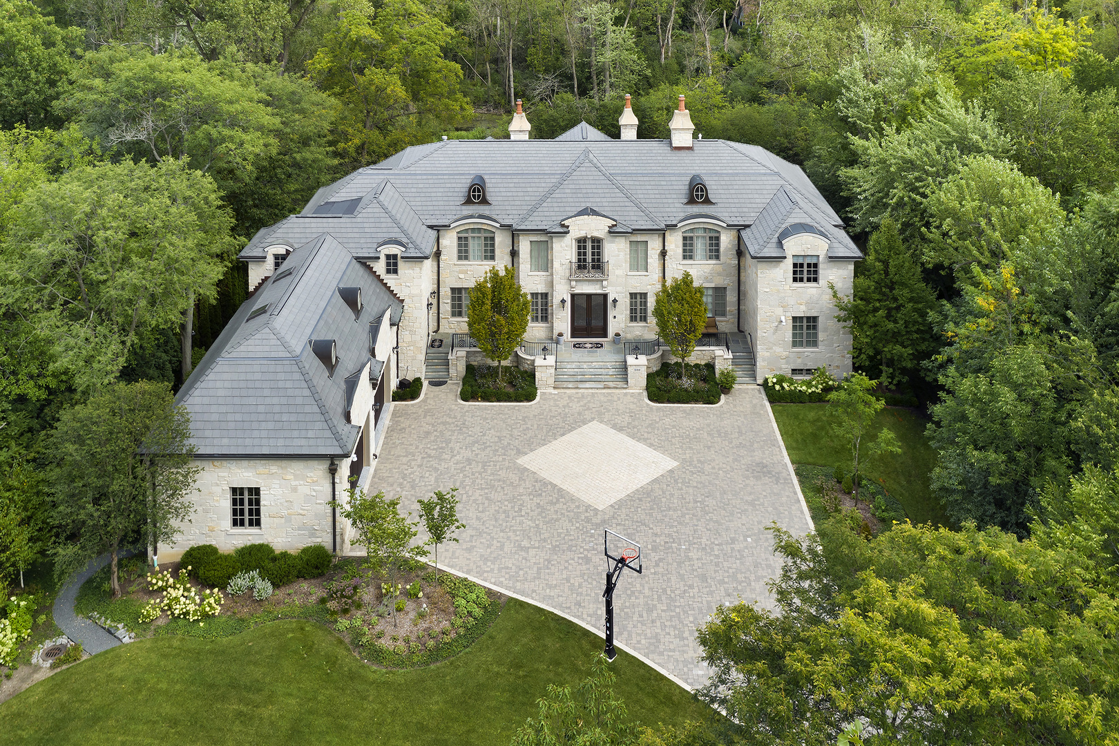 a aerial view of a house with yard and green space