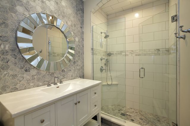 a bathroom with a sink toilet a mirror and shower