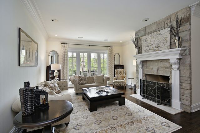 a living room with furniture and large windows
