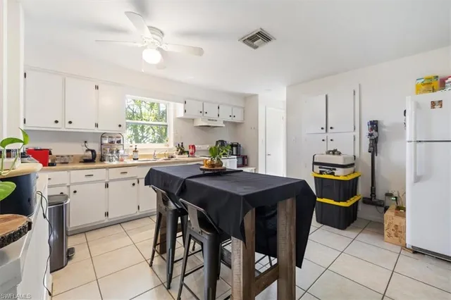 a kitchen with a table chairs and refrigerator