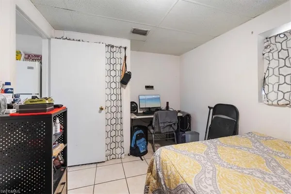 a bedroom with a bed and a chair in it