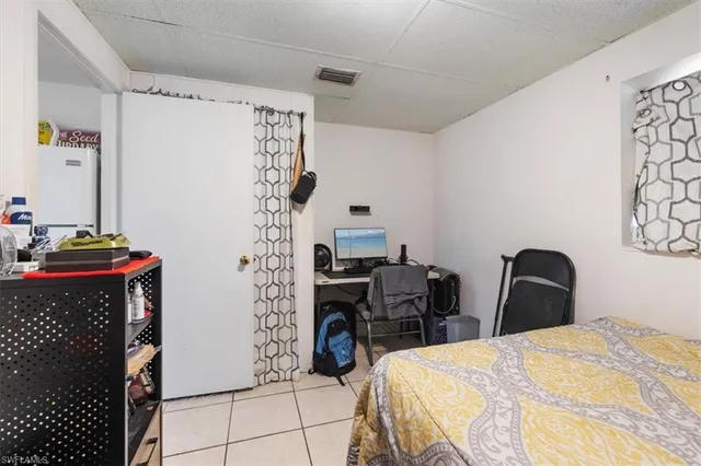 a bedroom with a bed and a chair in it