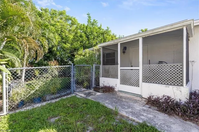 a backyard of a house with plants and outdoor seating