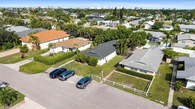 an aerial view of a tennis ground and a houses