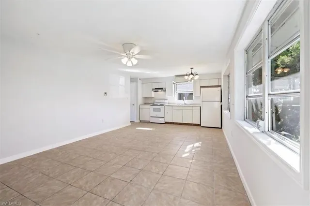 a view of a kitchen with a sink and a window