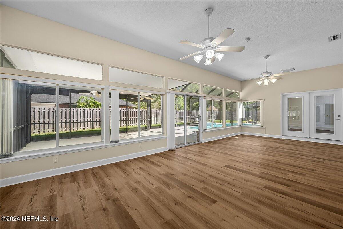 10285 Hamlet Glen Drive Jacksonville, FL 32221 - Photo 14 of 26 a view of an empty room with a window and wooden floor