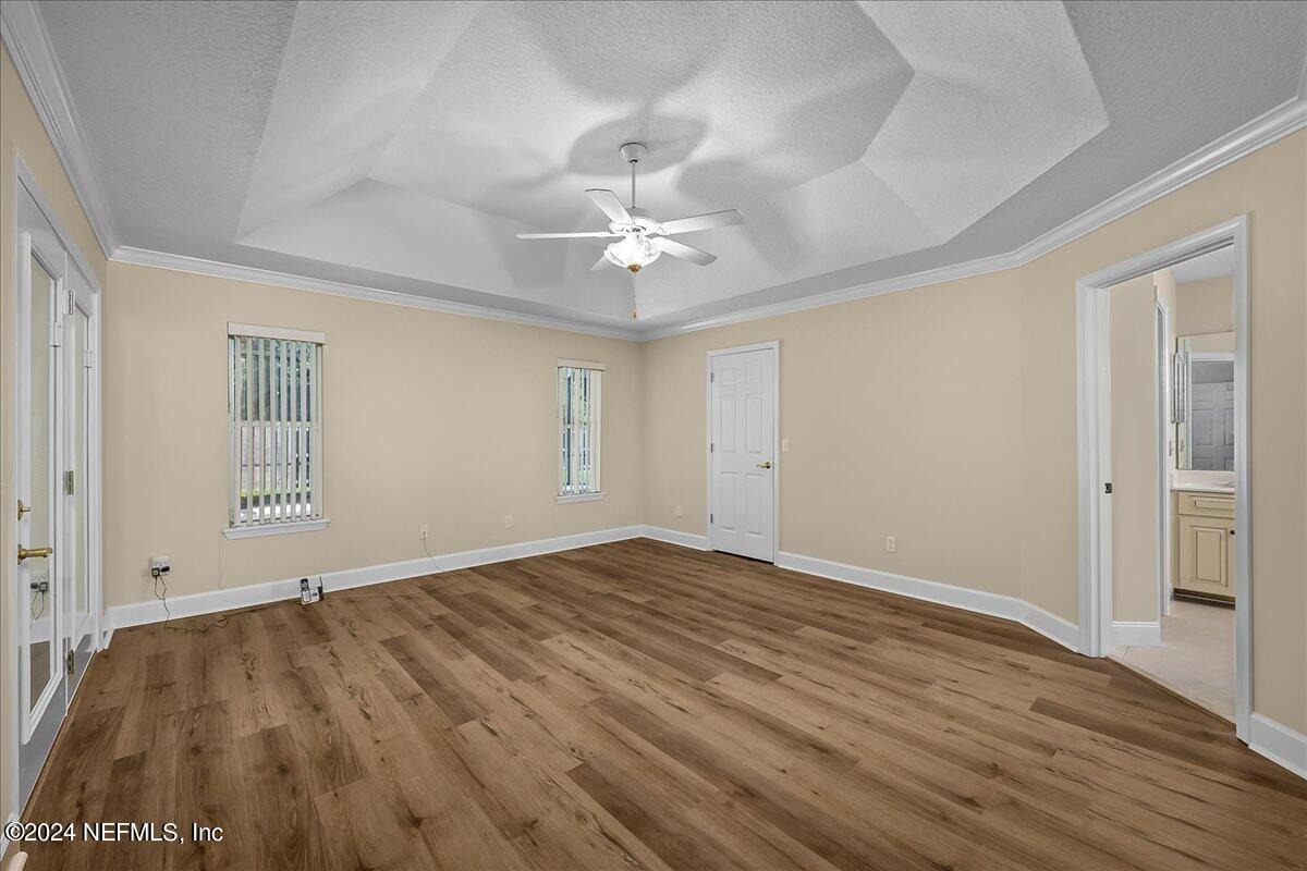 10285 Hamlet Glen Drive Jacksonville, FL 32221 - Photo 17 of 26 wooden floor in an empty room with a window