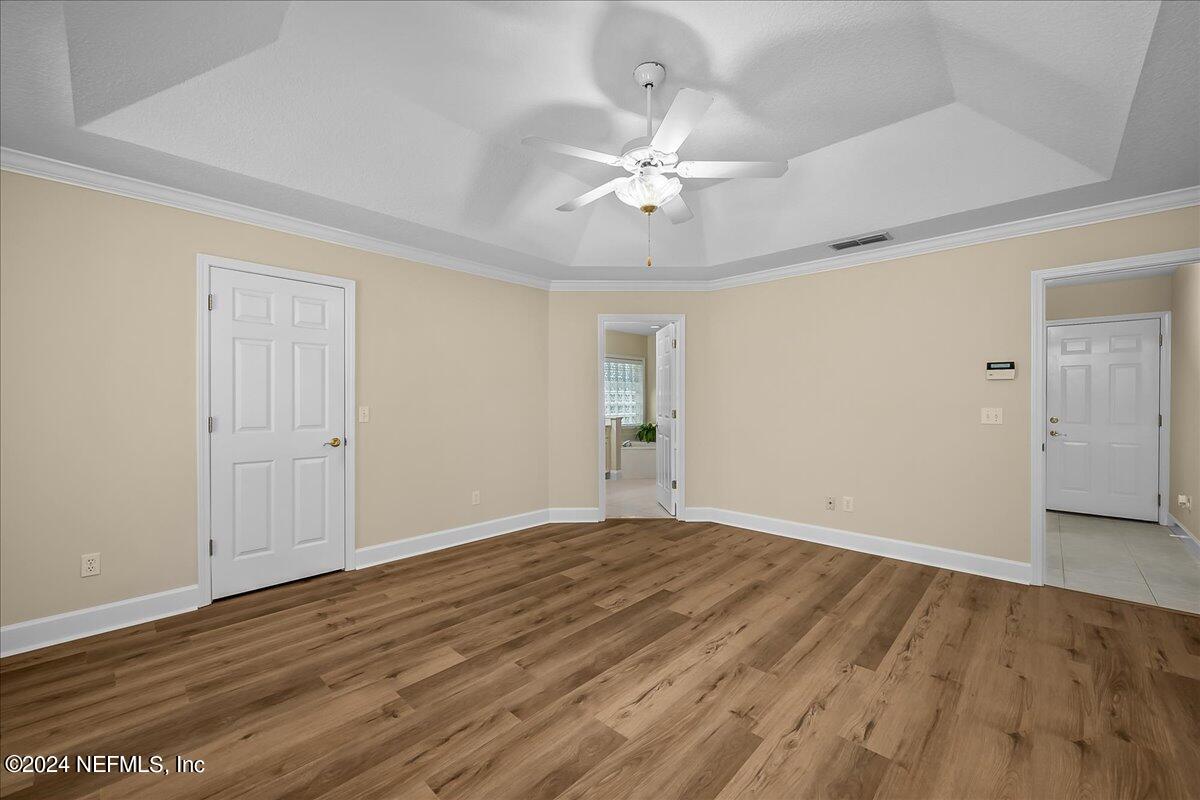10285 Hamlet Glen Drive Jacksonville, FL 32221 - Photo 18 of 26 a view of an empty room with wooden floor
