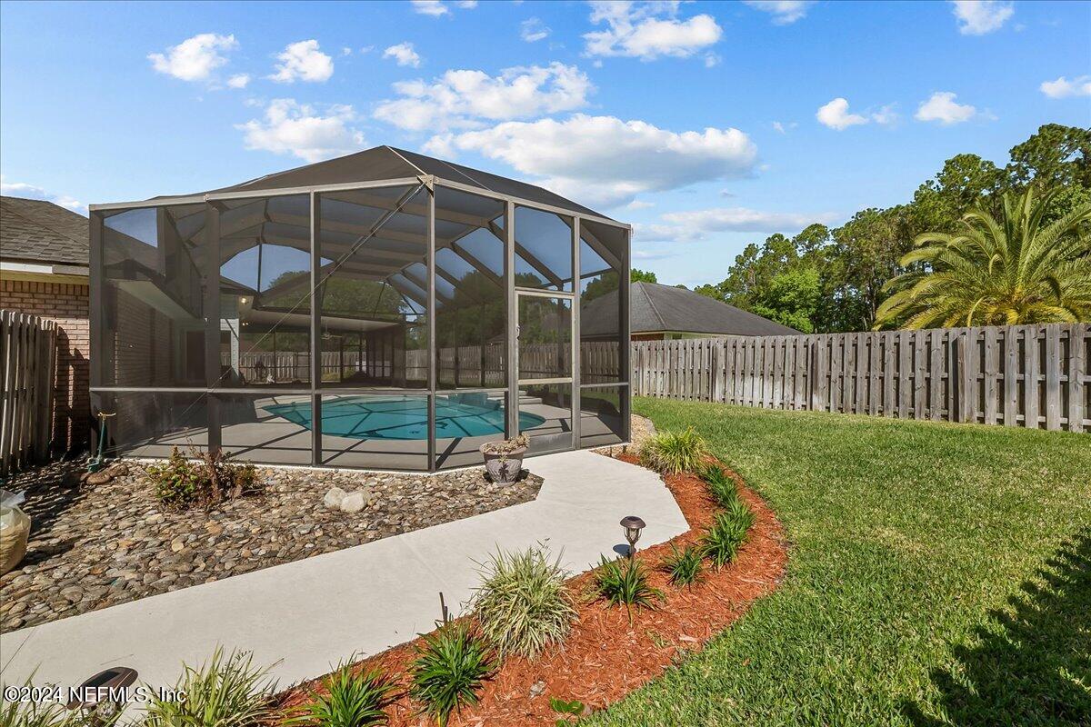10285 Hamlet Glen Drive Jacksonville, FL 32221 - Photo 24 of 26 a view of a house with a backyard