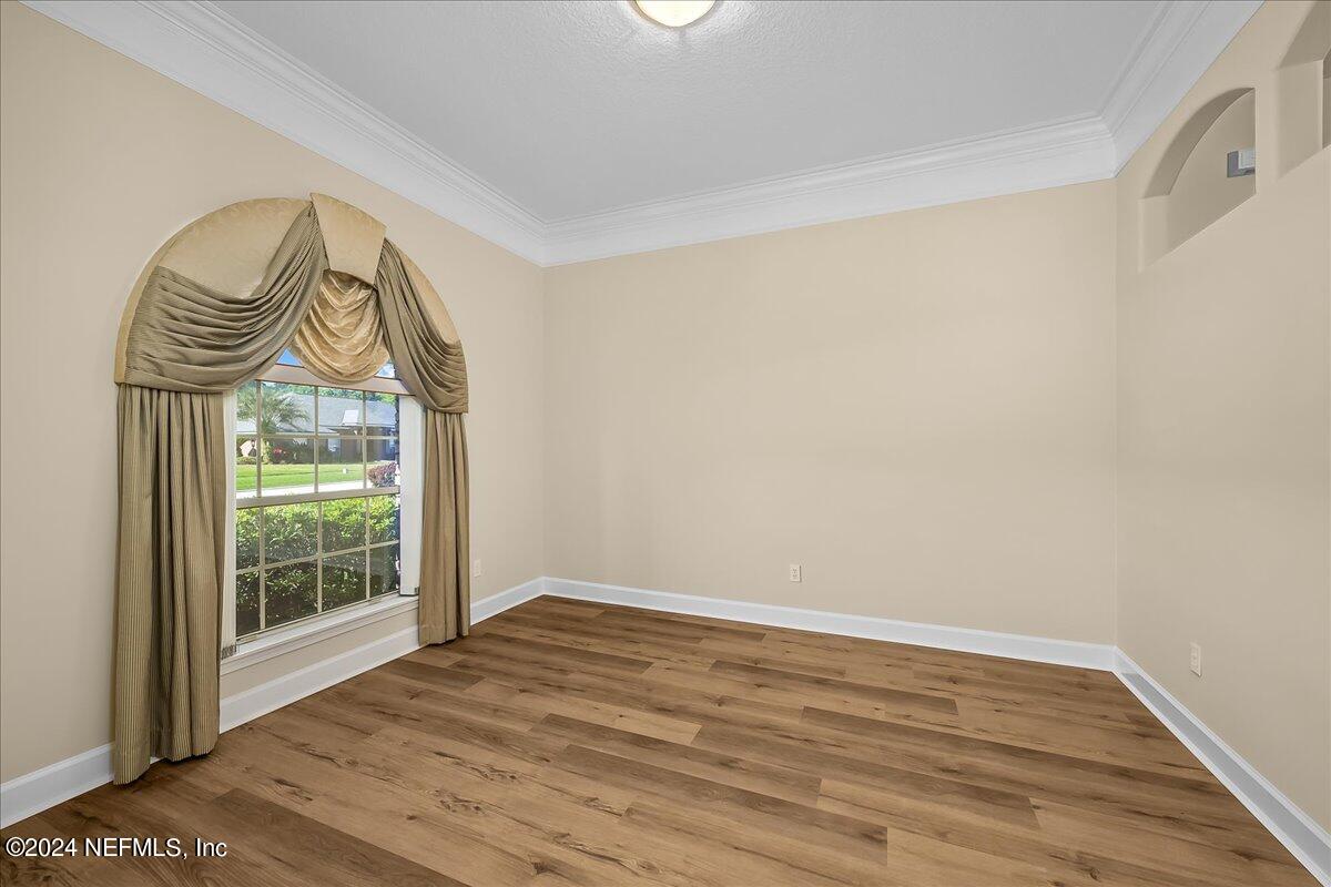 10285 Hamlet Glen Drive Jacksonville, FL 32221 - Photo 6 of 26 a view of wooden floor a sliding door and a window