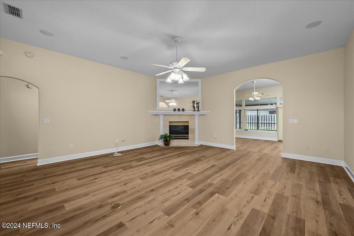 10285 Hamlet Glen Drive Jacksonville, FL 32221 - Photo 8 of 26 a view of an empty room with window and wooden floor