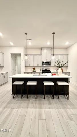 a living room with furniture a flat screen tv and a window