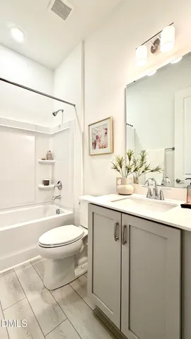 a room with granite countertop lots of wooden furniture and lots of counter top space