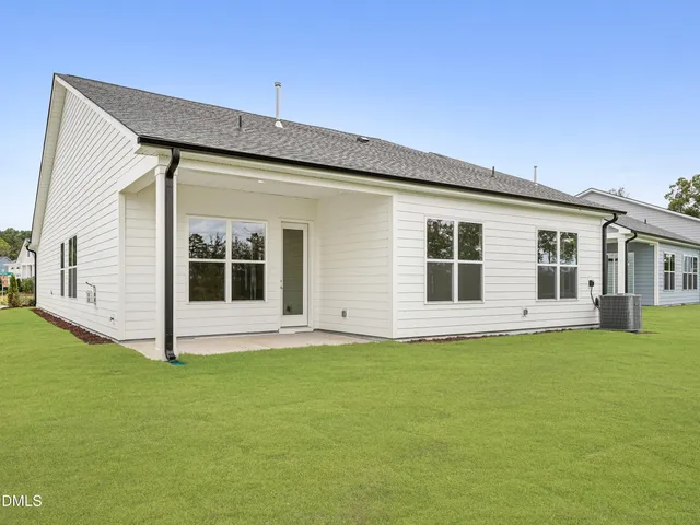 a view of tennis court with houses in the background