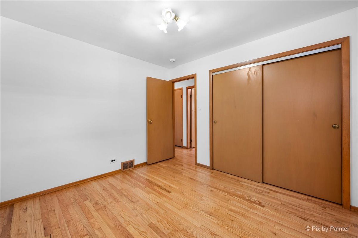 970 Fischer Drive Addison, IL 60101 - Photo 16 of 32 wooden floor in an empty room with a window