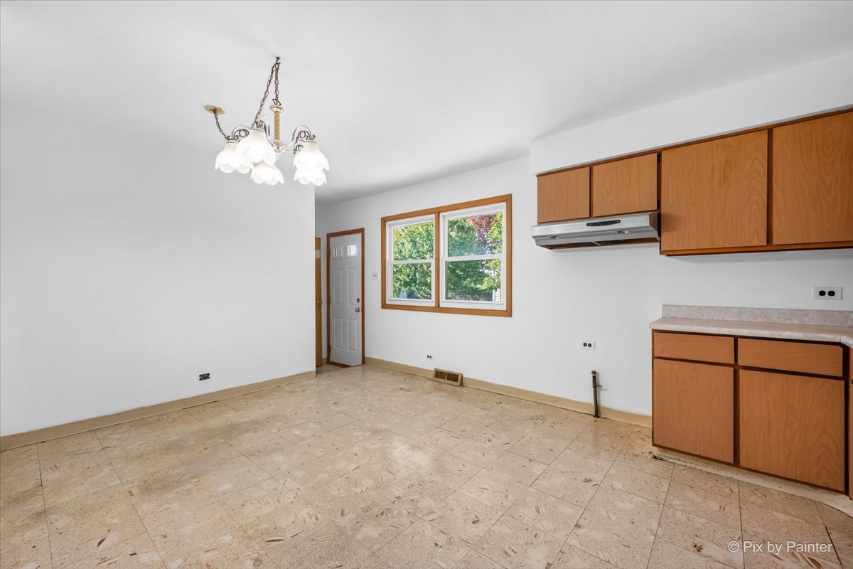 970 Fischer Drive Addison, IL 60101 - Photo 2 of 32 a view of a kitchen with an empty space and a window