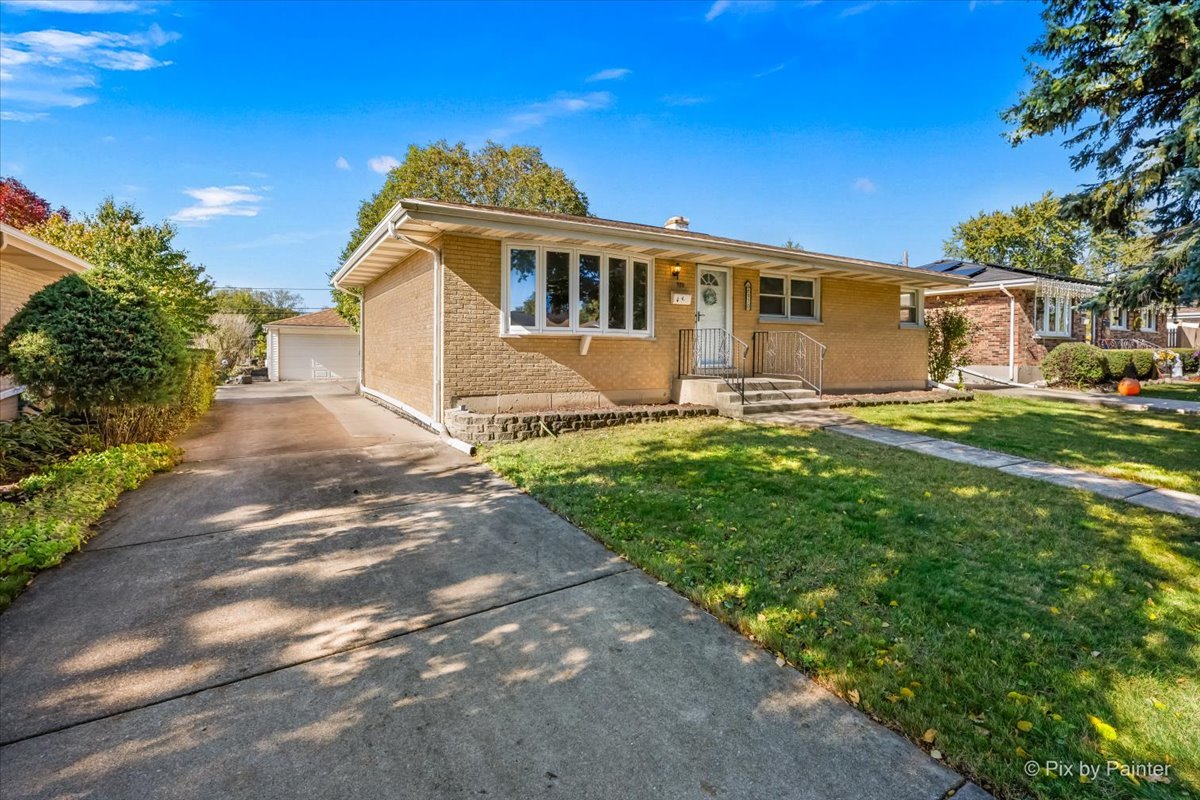 970 Fischer Drive Addison, IL 60101 - Photo 23 of 32 a front view of a house with a yard