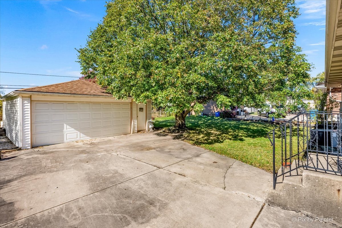 970 Fischer Drive Addison, IL 60101 - Photo 25 of 32 a front view of a house with a garden and yard